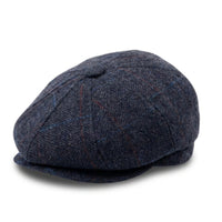 Herenpet in marineblauwe wollen tweedstof, model newsboy.