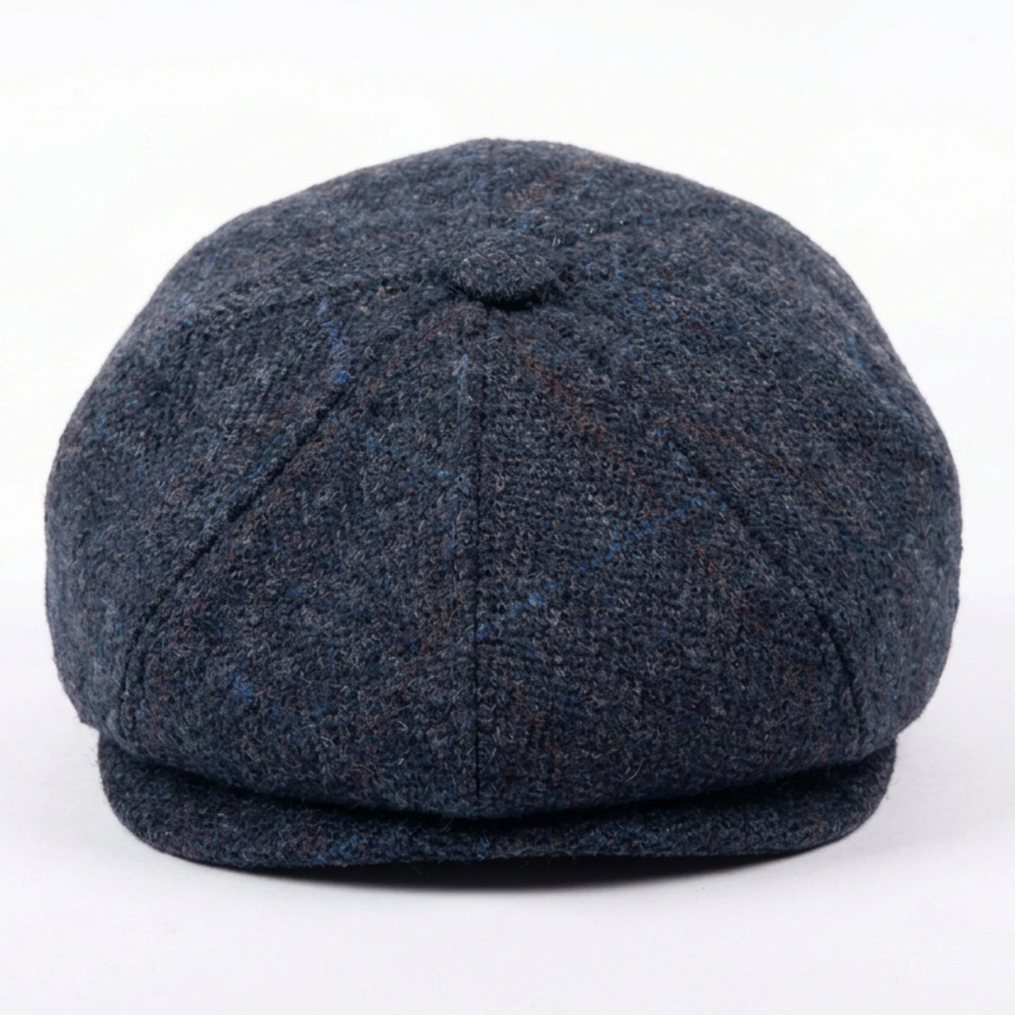 Herenpet in marineblauwe wollen tweedstof, model newsboy.